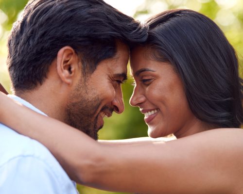 Portrait Of Loving Couple Outdoors In Garden Or Countryside